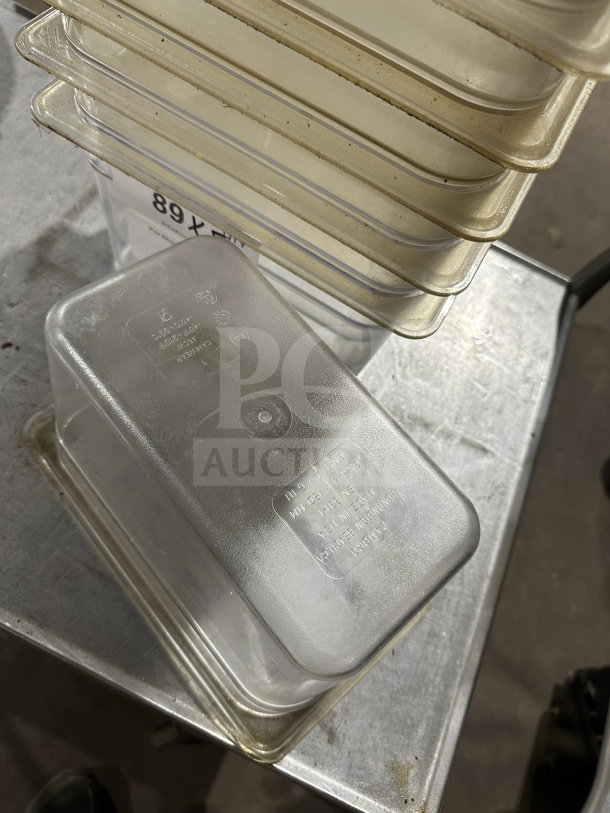 Cambro commercial polycarbonate translucent full-size food pan, stack of pans, used condition, visible model markings.