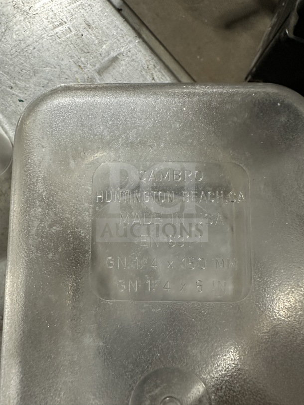 Cambro commercial polycarbonate translucent full-size food pan. Features embossed text: "Huntington Beach, CA, Made in USA," dimensions "GN 1/4 x 150 mm, GN 1/4 x 6 in."