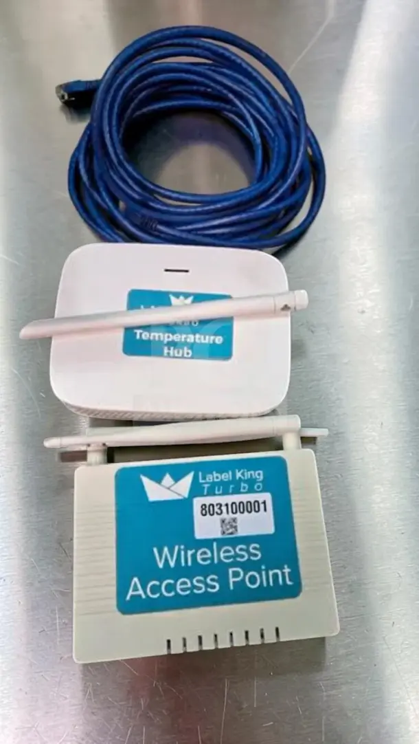 Label King Turbo system with wireless access point and temperature hub, featuring cables and antennas; fully operational.