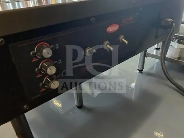 Hatco GRSDS-24T control panel with three dial settings and switches, powered on. Model label visible.