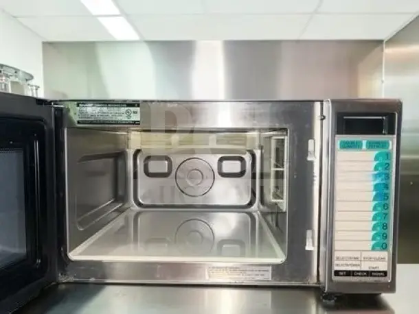 Sharp R-21LTF commercial microwave oven, 1,000 watts, 1.0 cu. ft., touch controls, NSF Listed, superb condition, open door view.