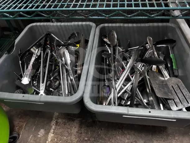 Two containers of well-maintained mixed commercial kitchen utensils, including tongs, spatulas, and ladles, suitable for restaurant use.