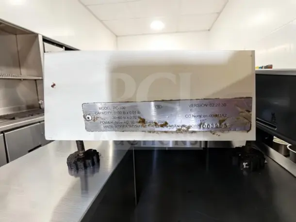 Skyfood PC-100-PL stainless steel price computing scale with pole display, 60 lb capacity, model label shown.