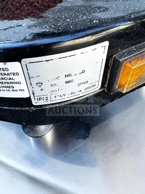 Close-up of a label on a Gino Rossi RR45 espresso grinder, showing model and serial number, operational at 120V-60Hz.