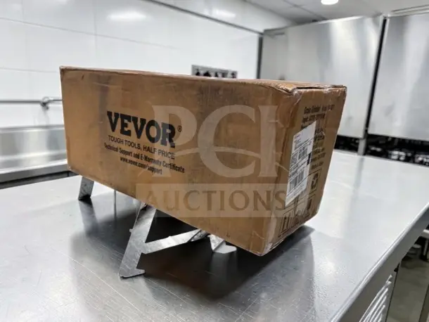 Brand new VEVOR GM-001 electric grain mill grinder in sealed box, featuring model and branding labels.