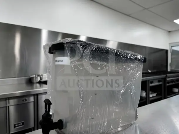 Plastic cold juice dispenser with spigot, like-new condition. Wrapped in protective plastic. Model: MIS-S-DISP-1227.