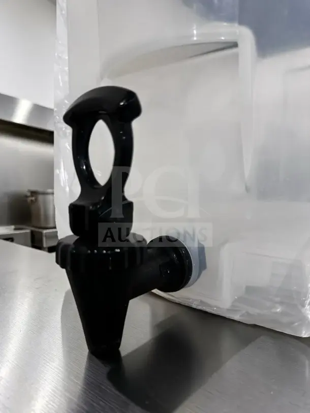 Plastic beverage dispenser with spigot, like-new, unbranded model. Clear container, ideal for countertop drink service.