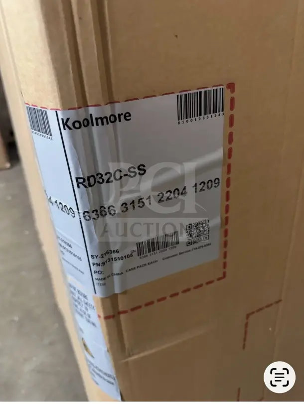 Brand new KoolMore RD32C-SS refrigerated deli display case in package. Model details and barcode visible on label.