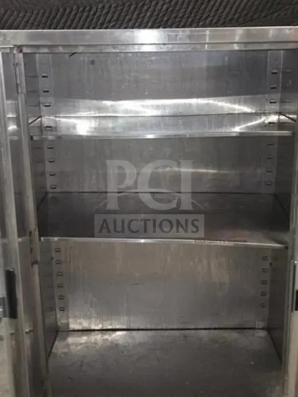 Stainless steel industrial storage cabinet, 34" x 18" x 54", two-door, commercial use, excellent condition.