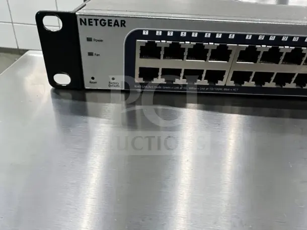 NETGEAR ProSAFE GS748Tv5, 48-Port Gigabit Ethernet Switch in high-grade condition, showing front ports and status indicators.