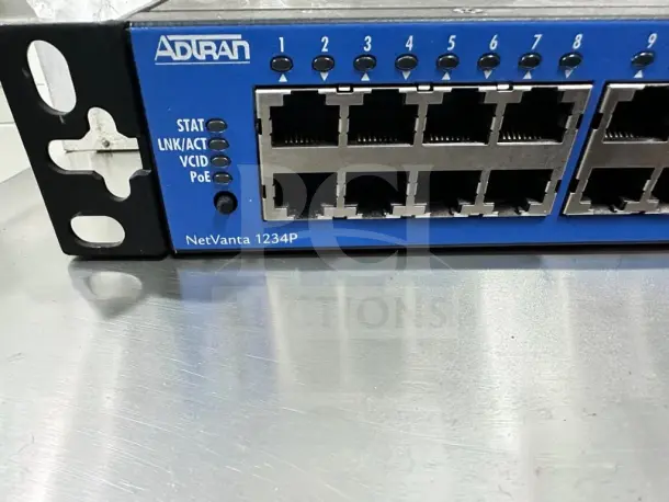 ADTRAN NetVanta 1234P 3rd Gen, 24-Port Fast Ethernet PoE Managed Switch, quad gigabit uplinks, model 1703595G1, fully operational.