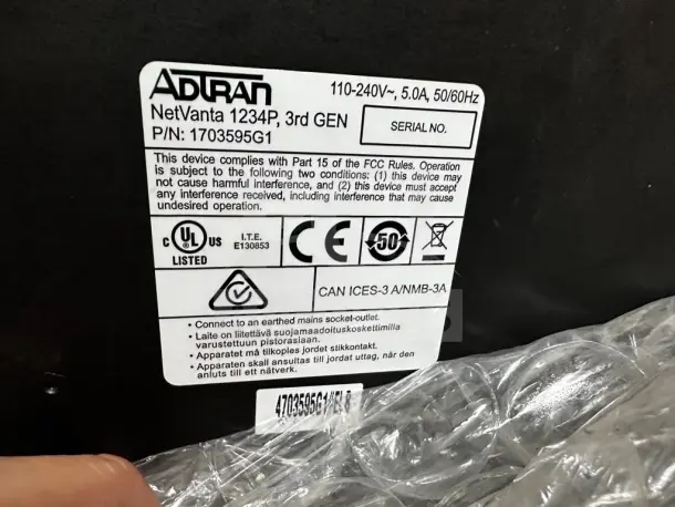 ADTRAN NetVanta 1234P 3rd Gen switch label, model 1703595G1, 24-Port Fast Ethernet, PoE, quad gigabit uplinks.
