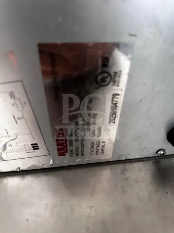 Alt text: Label on Kratos 28W-600 countertop food warmer showing model, voltage, and serial number details.