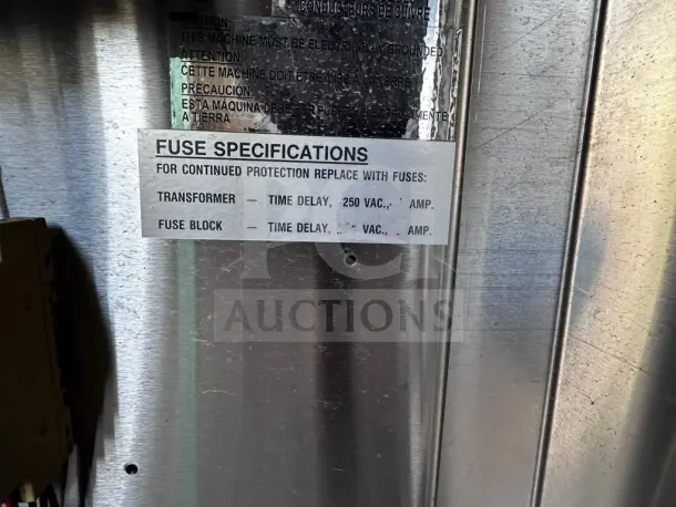 Industrial metal panel with fuse specifications label for LVO FL14F washer, detailing replacement fuses and electrical requirements.