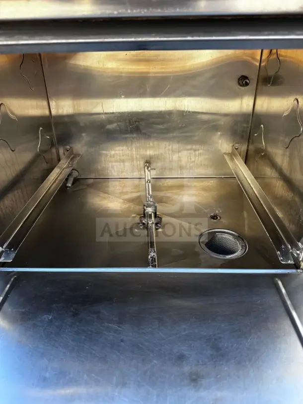 CMA Dishmachines L-1X undercounter dishwasher interior, stainless steel, well-maintained, holds 30 racks/hour, 115V.