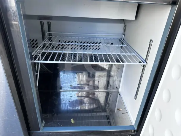 Arctic Air AST48RZ 48" refrigerated sandwich prep table, two-door, 12-pan capacity, 115V, interior shelves visible, tested.