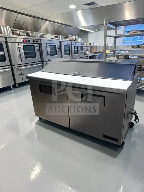 True TSSU-60-16 refrigerated sandwich prep table; 60", two doors, 16-pan capacity, well-maintained, fully operational.
