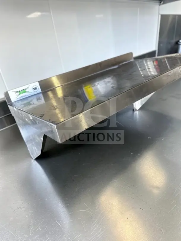 Regency 600WS1224 24"x12" NSF stainless steel wall shelf, new condition, 210-lb capacity, visible quality marks.