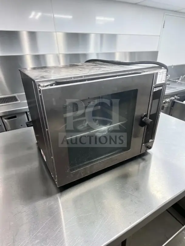 Doyon DCOT5 electric half-size convection oven, stainless steel, superior condition, ETL/NSF certified, 208V, single phase.