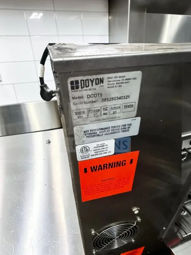 Doyon DCOT5 electric countertop convection oven, superior condition, ETL/NSF certified, tags displaying model and specs.