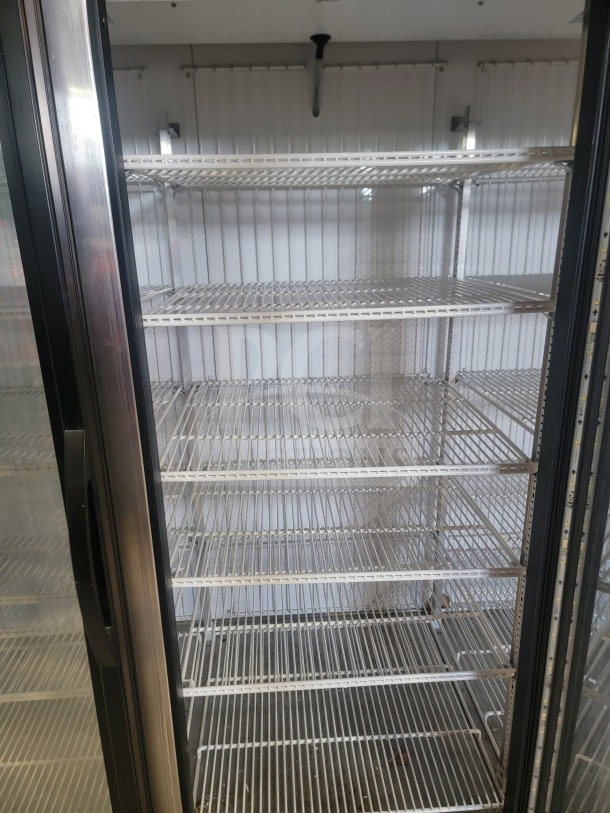 True GDM-72F-HC commercial 3-door glass merchandiser freezer with multiple wire shelves, in tested and working condition.