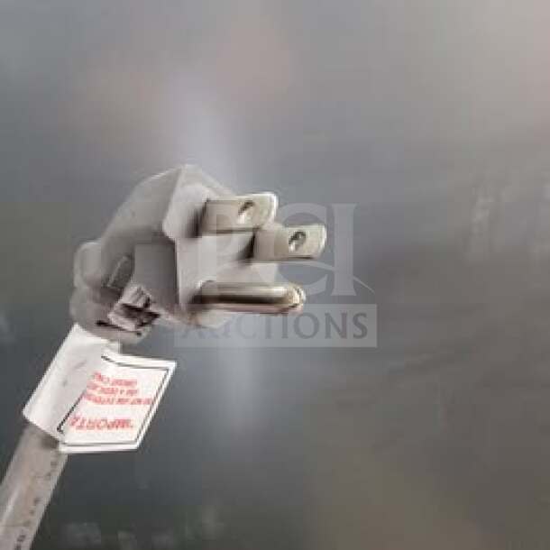 Maxx Cold MCF-49FD stainless steel reach-in freezer plug, commercial-grade, shown with tag indicating it is tested and working.
