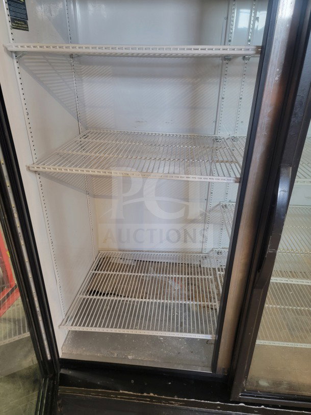 True GDM-49-HC commercial 2-door glass merchandiser refrigerator, white interior, wire shelving, tested and working.