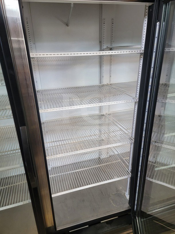 True GDM-72-HC Commercial 3-Door Glass Merchandiser Refrigerator, tested, working, with adjustable metal shelves.