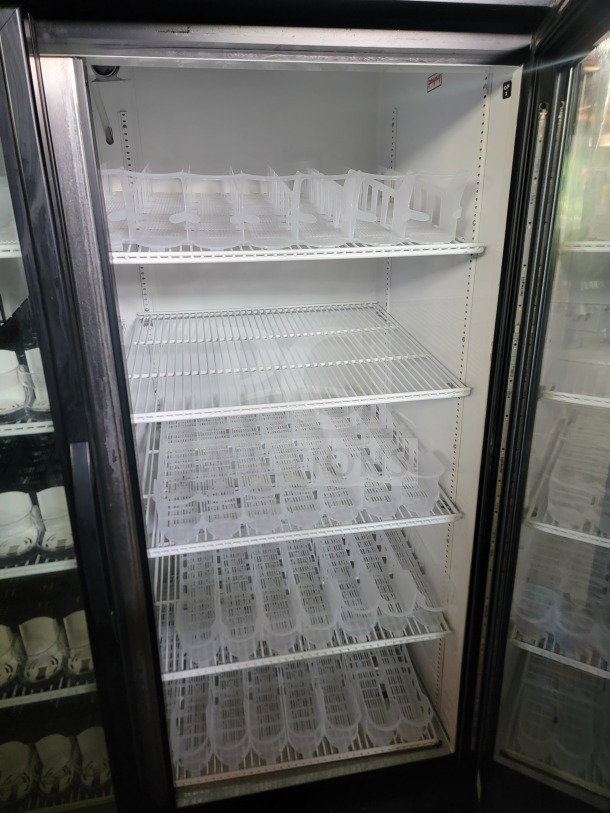 True GDM-49-HC commercial 2-door glass refrigerator, tested, working, spacious interior with shelving, ideal for retail.