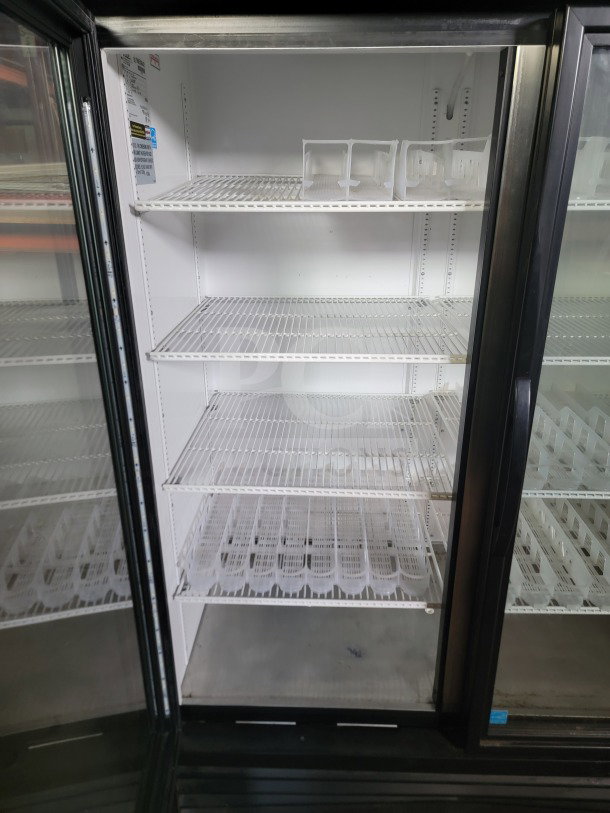 True GDM-49-HC 2-door glass merchandiser refrigerator, tested and working, with shelves, ideal for commercial use.