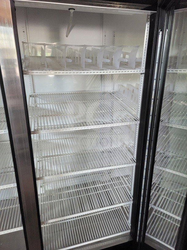 True GDM-72-HC 3-Door Glass Merchandiser Refrigerator with spacious shelves, ideal for displaying products. Tested and working.
