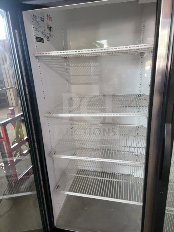 True GDM-72-HC 3-door glass merchandiser refrigerator, tested and working, ideal for commercial use, clean with white wire shelves.