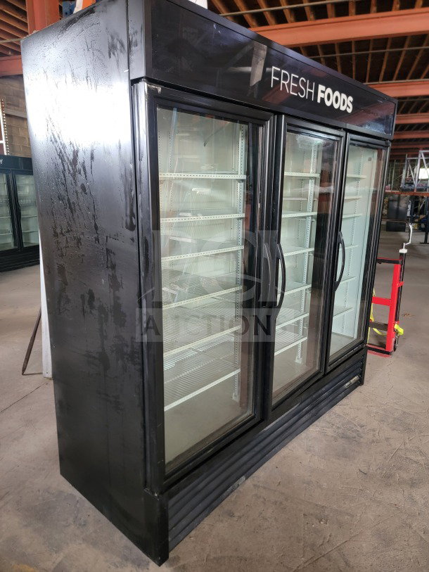 True GDM-72-HC 3-door glass merchandiser refrigerator, professional-grade, tested, working, black exterior, "Fresh Foods" label.