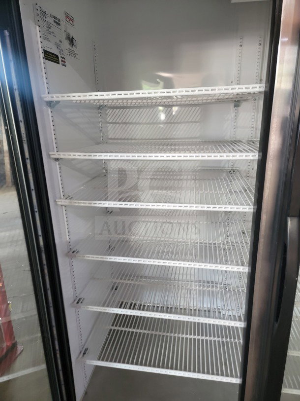 True GDM-72-HC 3-door glass merchandiser refrigerator, in excellent condition, with multiple wire shelves for display.