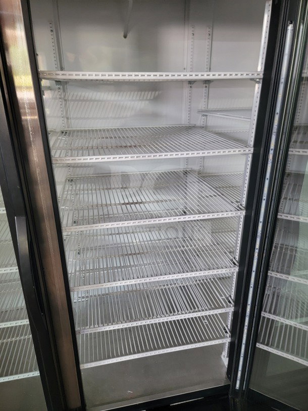 True GDM-72-HC commercial 3-door glass merchandiser refrigerator, multiple white wire shelves, tested and working condition.