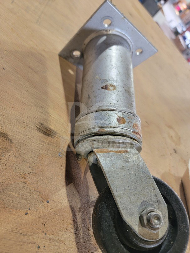 Middleby Marshall conveyor oven swivel caster, model 22290-0010, heavy-duty, worn condition, plate with four holes.