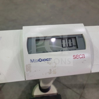 SECA 703 digital scale with BMI, hold, and tare functions; 550 lb capacity, robust design, and integrated wheels.