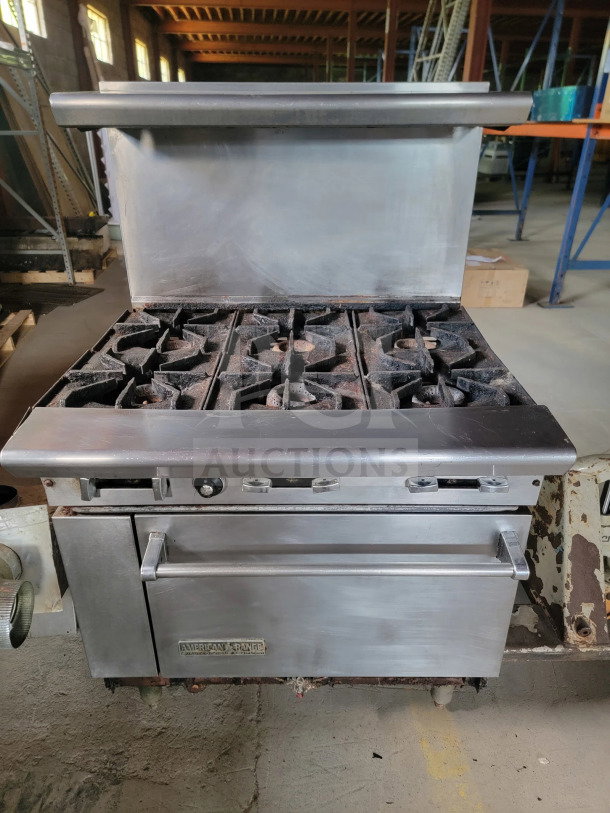 American Range 36" AR-6 6-burner gas range with standard oven, pre-owned, includes bonus ventilation parts. Visible wear, stainless steel.