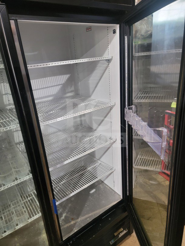 True GDM-72-HC commercial 3-door glass merchandiser refrigerator, tested, working, featuring wire shelves and clear glass doors.