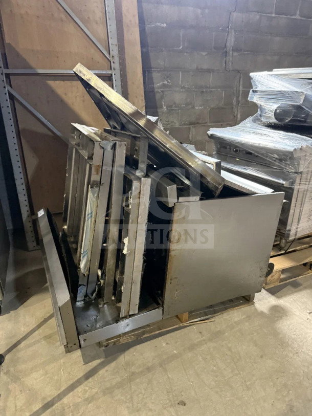 730 lb pallet of stainless steel scrap metal with structural pieces, panels, and shelving, stacked on a wooden pallet.
