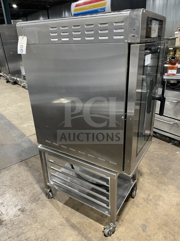 Alto Shaam 2021 electric multi-cook oven, model VMCH4H, stainless steel, 4 zones, on casters, with storage shelf and pan rack.