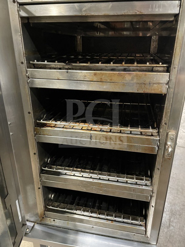 Alto Shaam 2021 VMC-H4H multi-cook oven, stainless steel, 4 chambers, individual controls, metal racks, on casters.