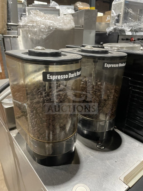 Melitta Cafina Series CT82G2TFWO01/ST stainless steel espresso machine with dual bean hoppers labeled "Espresso Dark Roast" and "Espresso Medium Roast."
