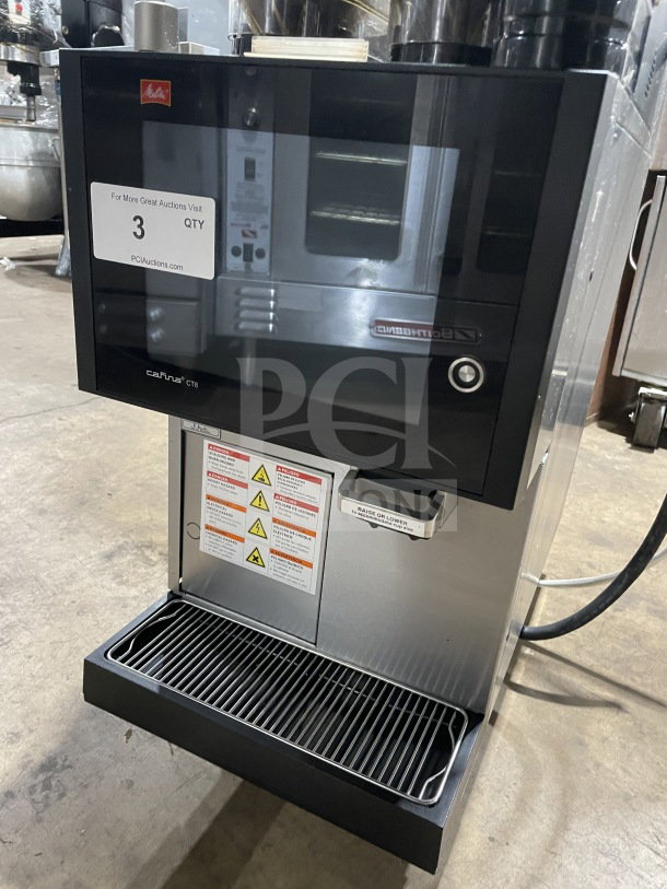 Melitta Cafina CT8 espresso machine, stainless steel, model CT82G2TFWO01/ST, 208V, 2 phase, commercial use, warning labels visible.
