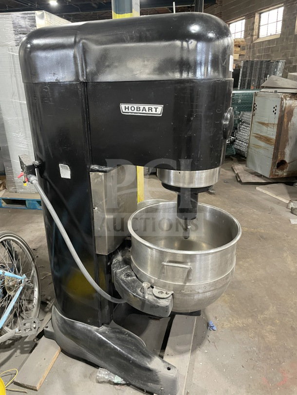 Hobart commercial charcoal black electric planetary dough mixer with mixing bowl and dough hook attachment.