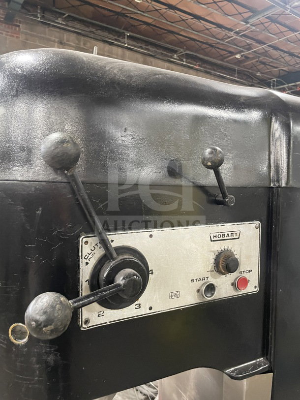 Hobart commercial charcoal black electric planetary dough mixer with control panel, mixing bowl, and dough hook attachment, in used condition.