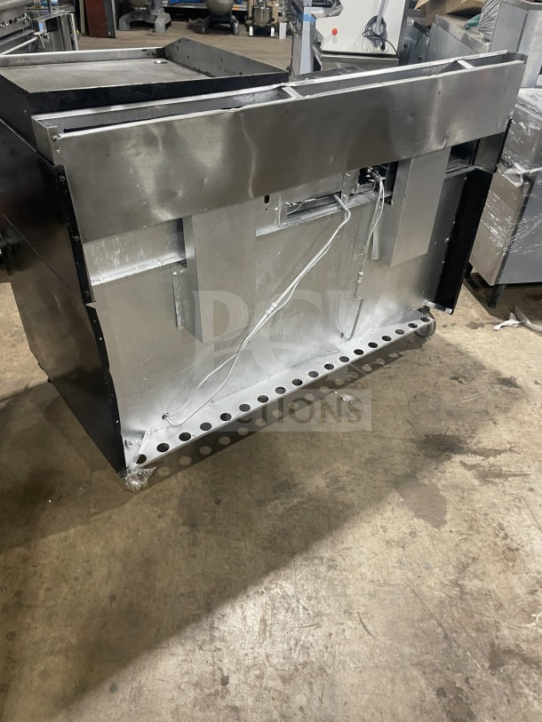 Garland commercial stainless steel gas range top view, showing stainless steel construction, wiring detail, and robust build.