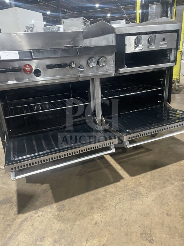 Garland stainless steel 6-burner range with raised flat griddle, double oven, broiler, salamander shelf, and casters.