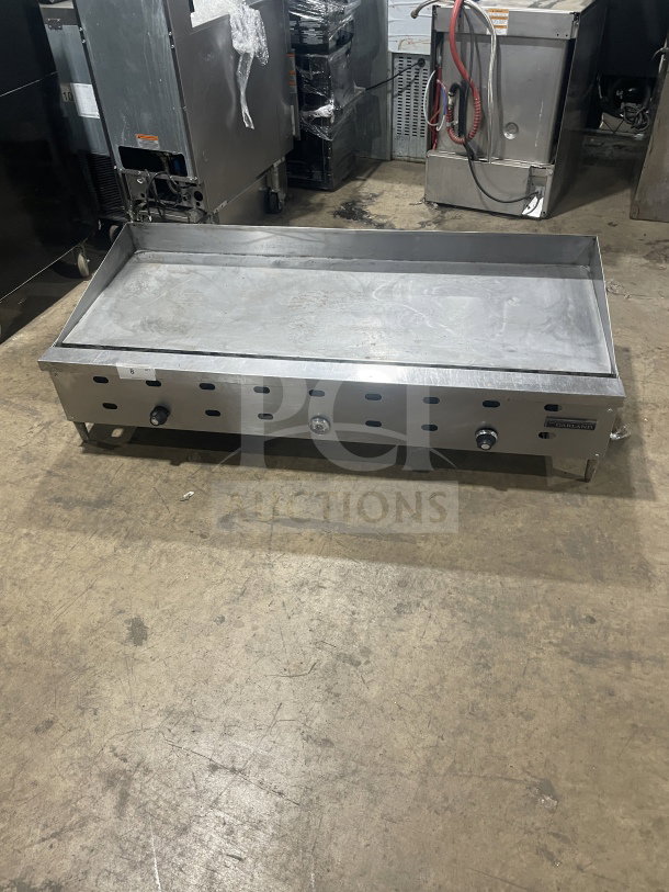 Garland commercial stainless steel countertop gas griddle on legs, features three knobs, durable build, used condition.