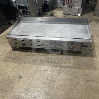 Garland commercial stainless steel countertop gas griddle on legs, features three knobs, durable build, used condition.